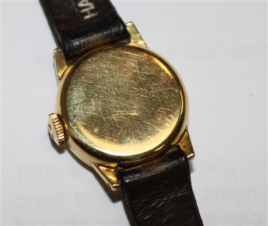 A ladys 1950s 18ct gold Omega manual wind wrist watch.